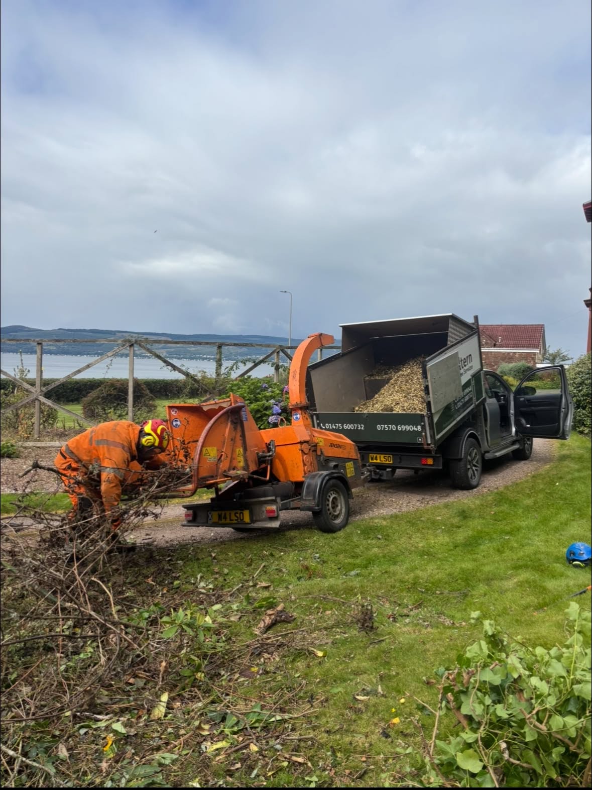 Altern Tree Services vehicle and wood chipper working in a coastal garden